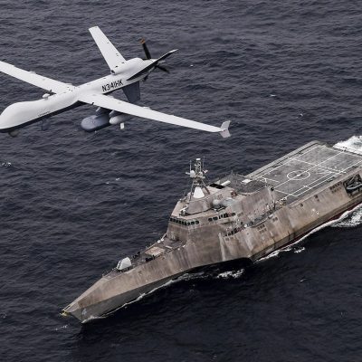 In this handout image from the U.S. Navy, an MQ-9 Sea Guardian unmanned maritime surveillance drone flies over the USS Coronado in the Pacific Ocean during a drill April 21, 2021. The U.S. Navy's Mideast-based 5th Fleet said Wednesday, Sept. 8, 2021, it will launch a new task force that incorporates airborne, sailing and underwater drones after years of maritime attacks linked to ongoing tensions with Iran. (U.S. Navy/Chief Mass Communication Specialist Shannon Renfroe, via AP)