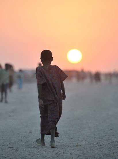 A Somali girl walks down a road at sunset in an IDP camp near the town of Jowhar. (Source: Original public domain image from Flickr)