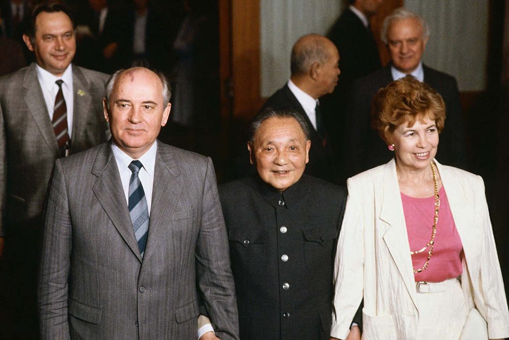 China's head of state, Deng Xiaoping (center), holds the hands of Mikhail and Raisa Gorbachev during a visit by the Soviet leader to China. Behind Raisa Gorbachev is Soviet Foreign Minister Eduard Shevardnadze. (Photo by Peter Turnley/Corbis/VCG via Getty Images)