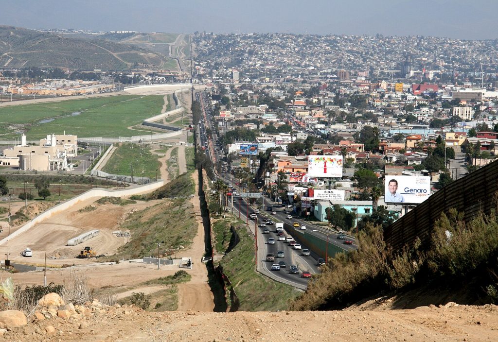 A small fence separates densely populated Tijuana, Mexico, right, from the United States in the Border Patrol's San Diego Sector (Photo: Wikimedia Commons)