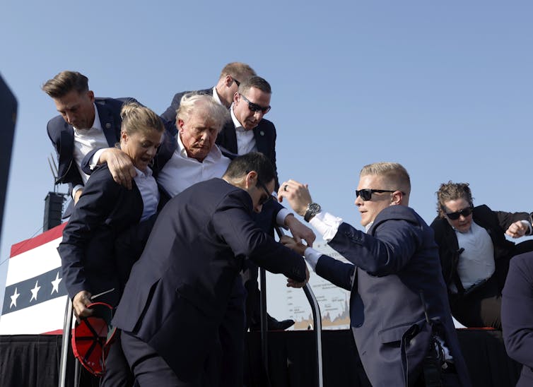 U.S. Secret Service agents help former President Donald Trump offstage during a rally on July 13, 2024, in Butler, Pa. (Photo: Anna Moneymaker / Getty Images)
