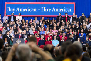 President Donald Trump delivers remarks on Wednesday, March 15, 2017, at the American Center for Mobility in Ypsilanti, Michigan. Photo source: Official White House Photo / Shealah Craighead / Trump White House Archived / Flickr, Public Domain.