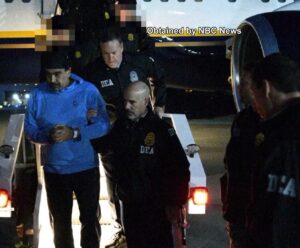 Nicolás Maduro being escorted by the DEA. Photo source: Drug Enforcement Administration / Wikimedia Commons, Public Domain. 