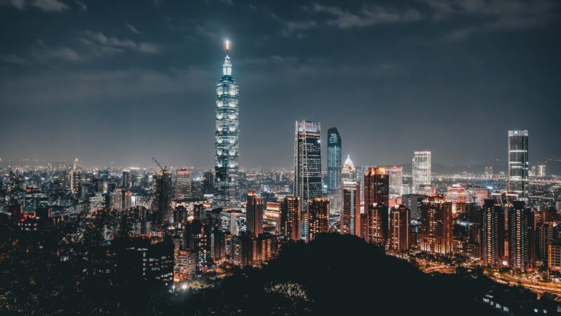 Night view of the Taipei skyline featuring the illuminated Taipei 101 amid modern skyscrapers. Photo source: Ehsan Haque / Pexels.