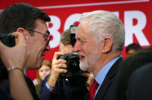 Jeremy Corbyn, Leader of the Labour Party (UK) on the right of the picture, with Andy Burnham, Mayor of Greater Manchester (left of picture) at the 2018 Labour Party (UK) Local Elections Launch in Trafford, Greater Manchester. Photo source: Sophie Brown / Wikimedia Commons, CC BY-SA 4.0